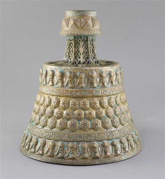 A 13th century Khorassan silver and copper inlaid bronze candlestick, H.10.5in.